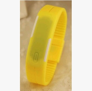 Yellow LED wristband on a beige fabric background