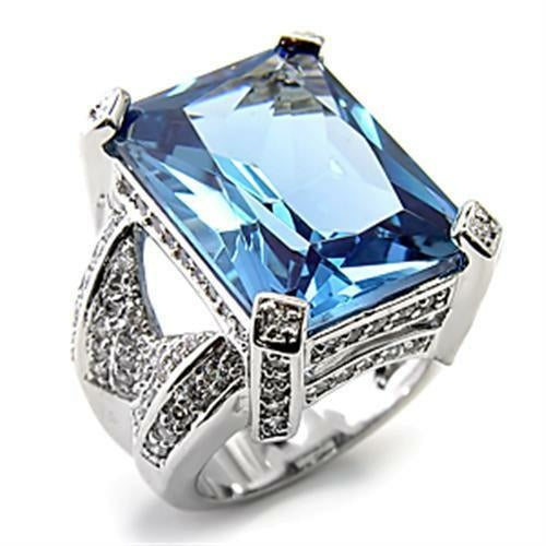 Ring with a large blue gemstone and silver accents on a white background