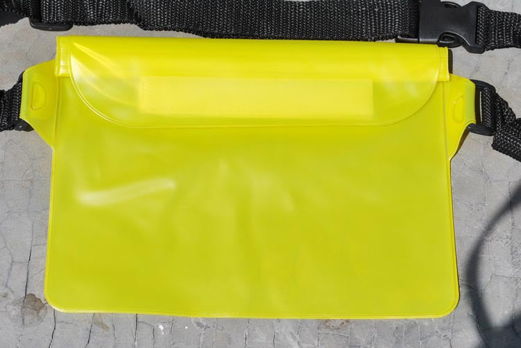 Yellow waist bag with a black strap on a concrete surface