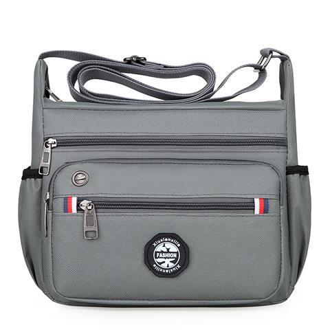 Gray shoulder bag with multiple pockets and a visible brand logo on a white background
