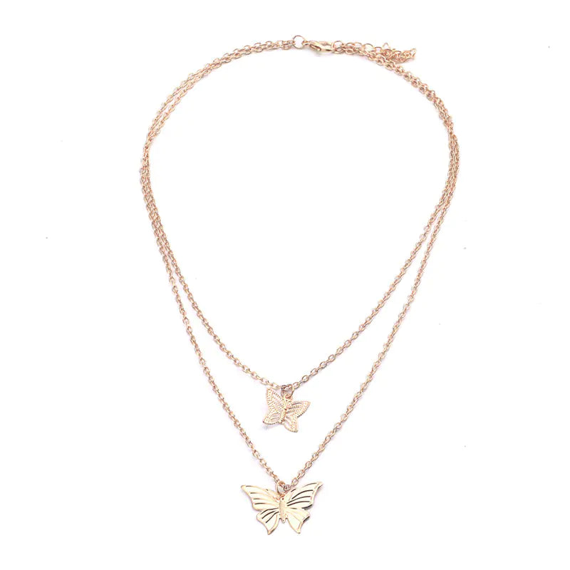 Rose gold butterfly necklace on a white background