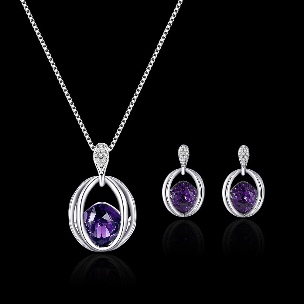 Silver jewelry set with blue gemstones on a black background
