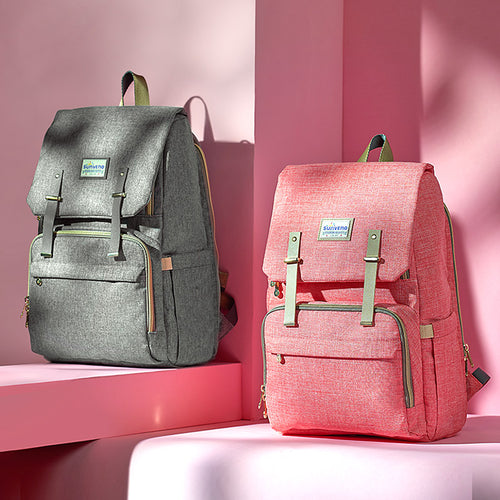 Gray and pink backpacks on a pink background