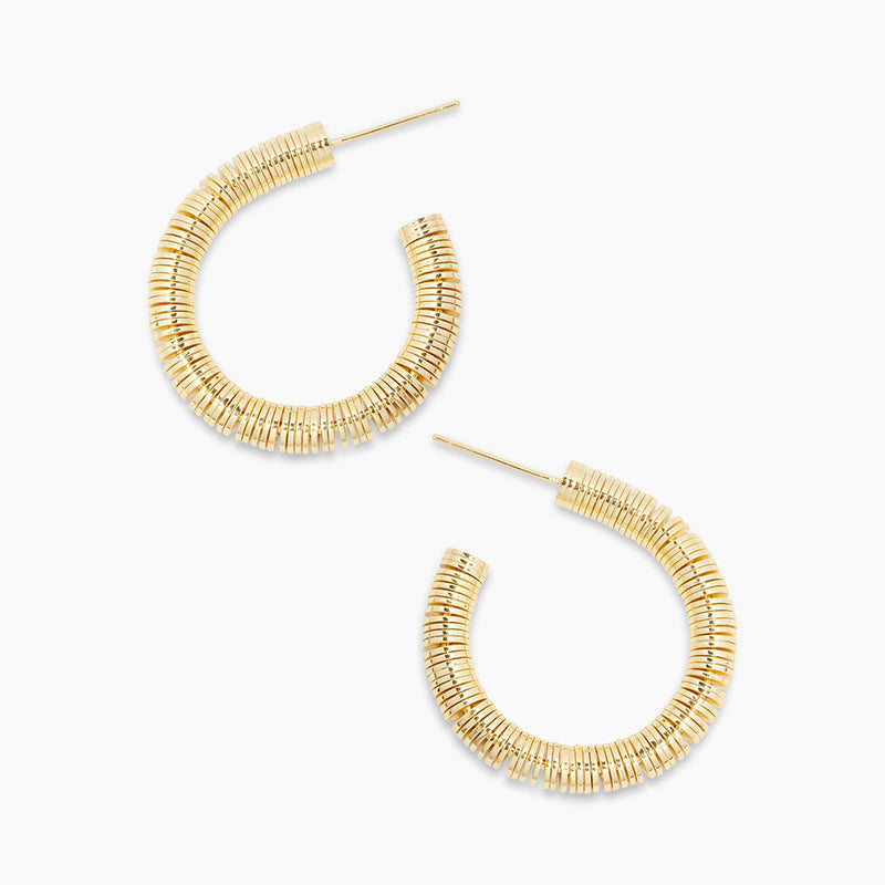 Gold hoop earrings on a white background