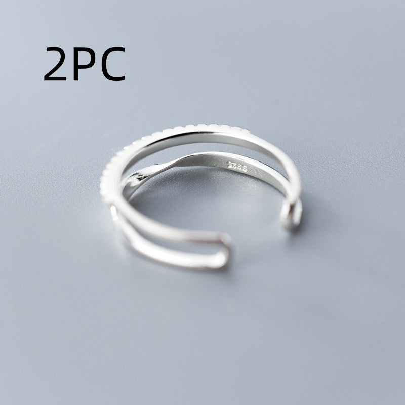 Silver ring with '2PC' text on a gray background