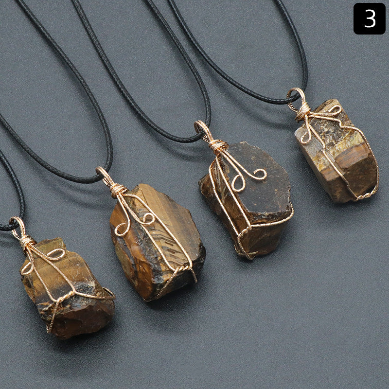 Five stone pendants on black cords against a gray background