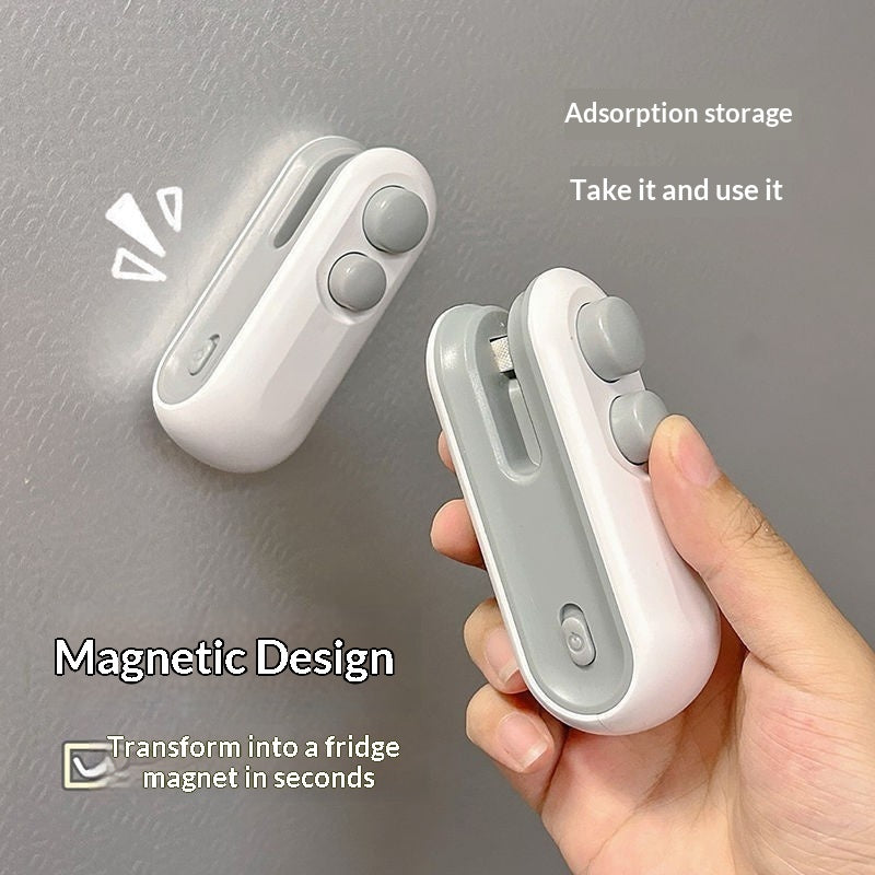 White and gray magnetic device held by a hand against a gray background