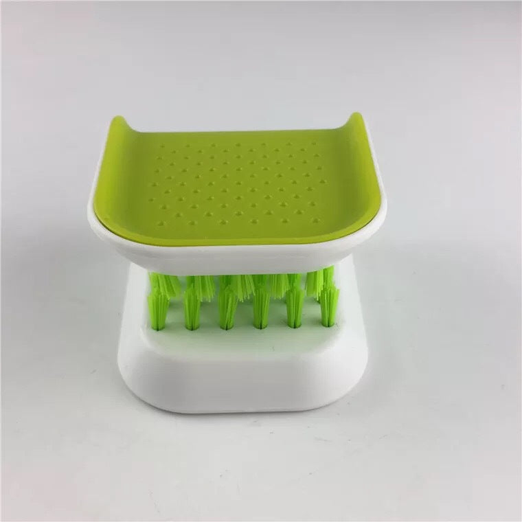 Green and white kitchen scrubber on a light gray background