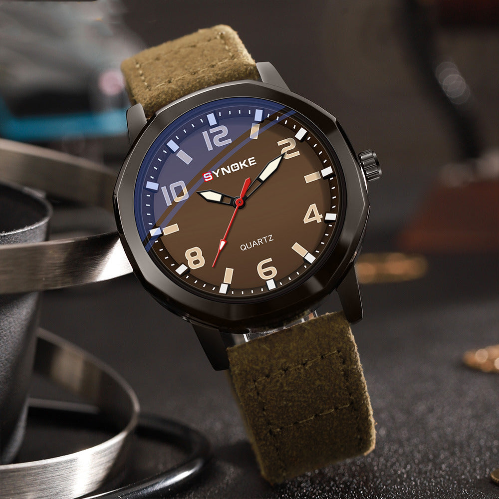 Watch with brown strap and brown dial on a dark surface