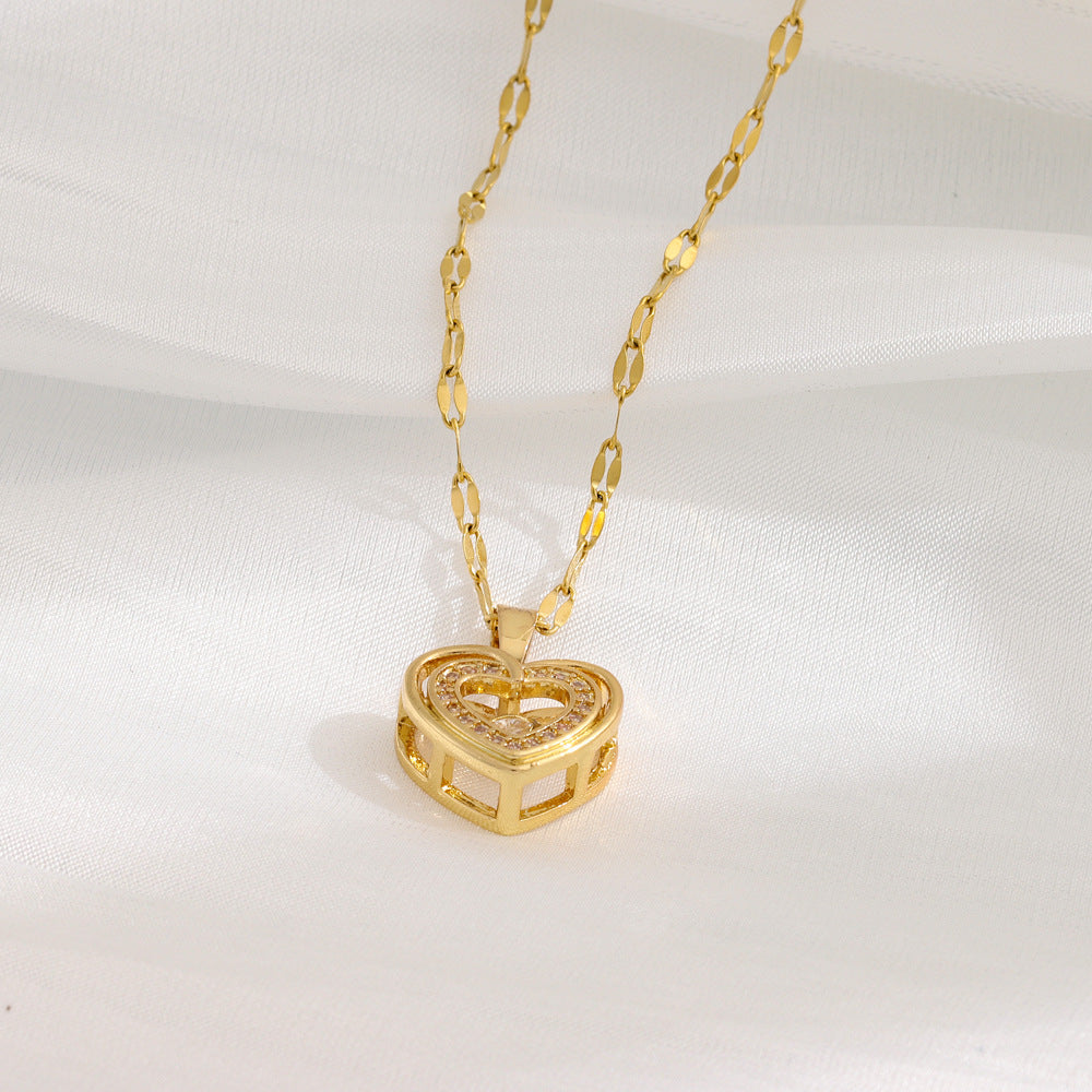 Gold heart-shaped pendant necklace on a white background