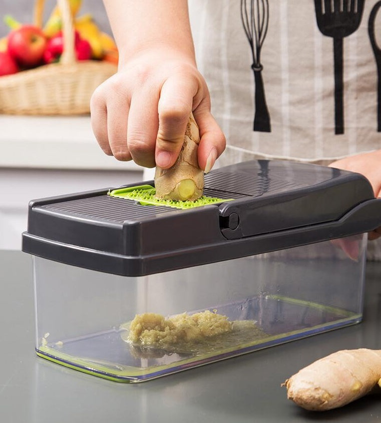 Person using a ginger grater on a kitchen counter with fruits in the background