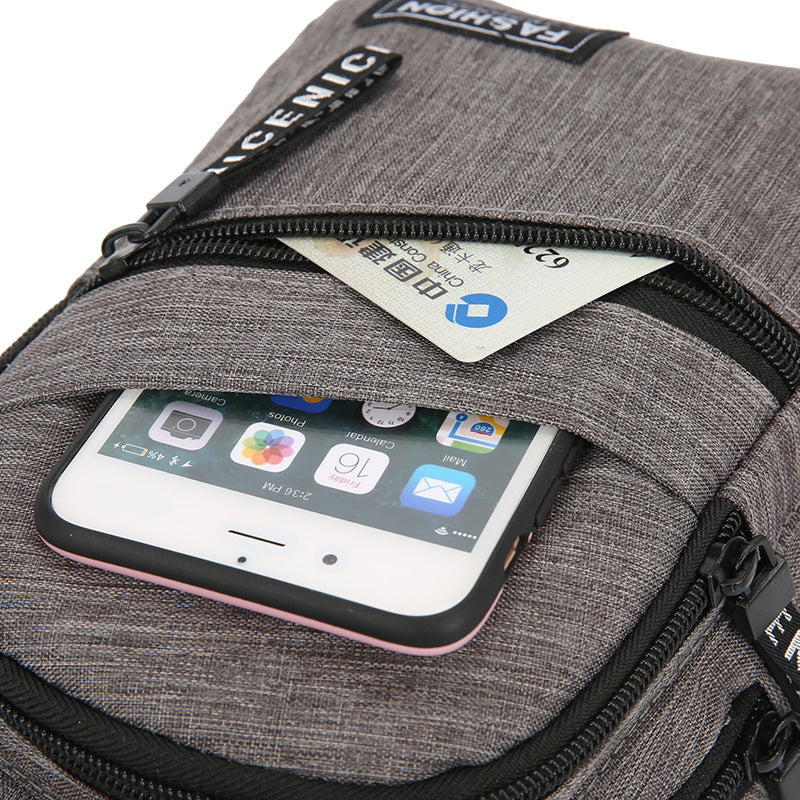 Gray backpack with a phone and card in an open compartment, featuring the brand 'Racenic'.