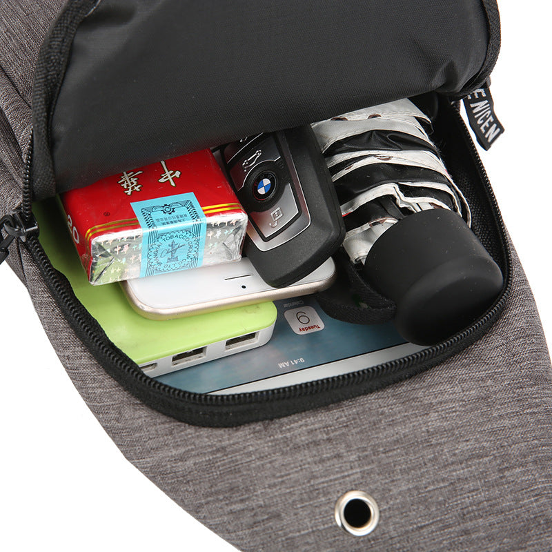 Gray pouch with various items including a phone, keys, and a wallet.