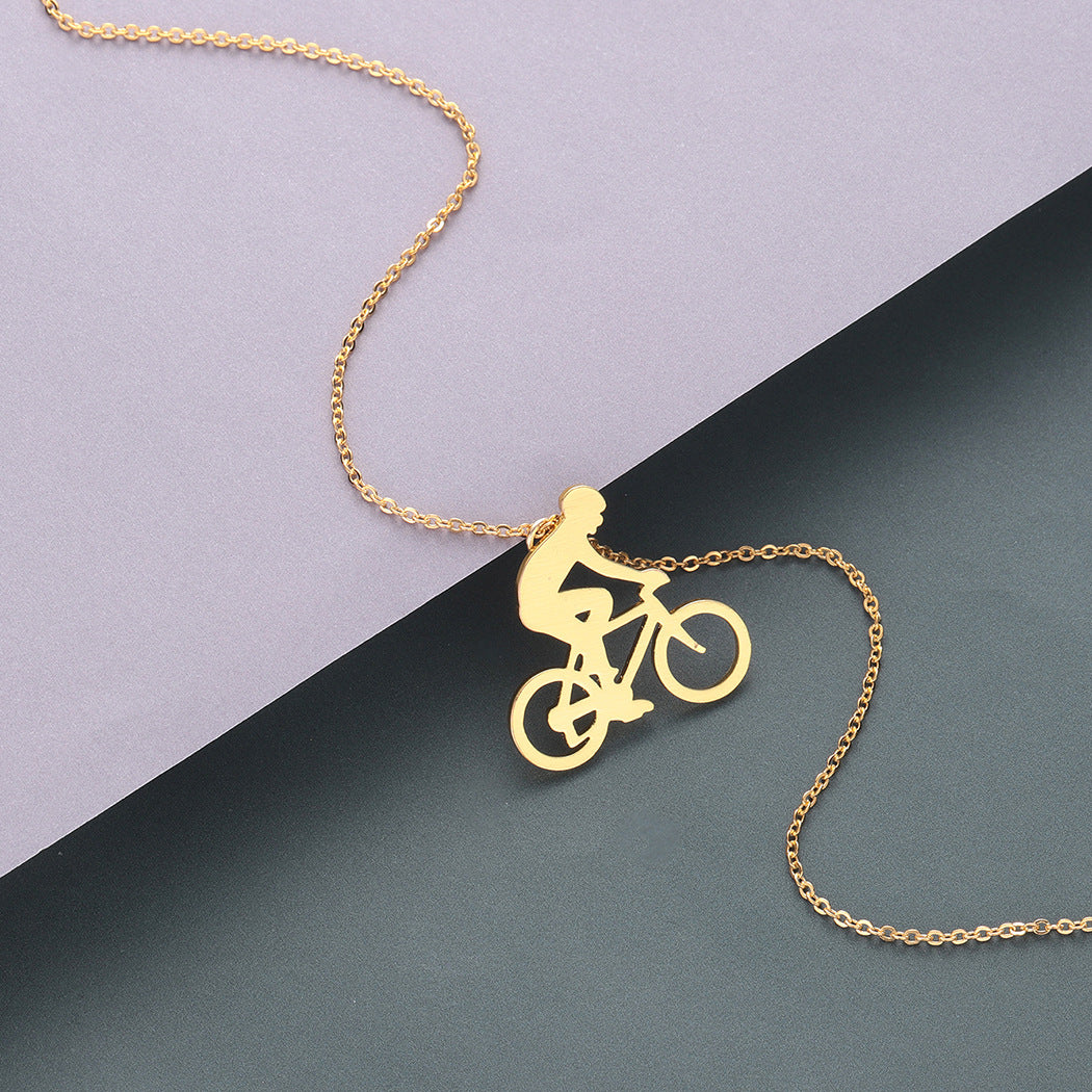 Gold necklace with a bicycle pendant on a two-tone background