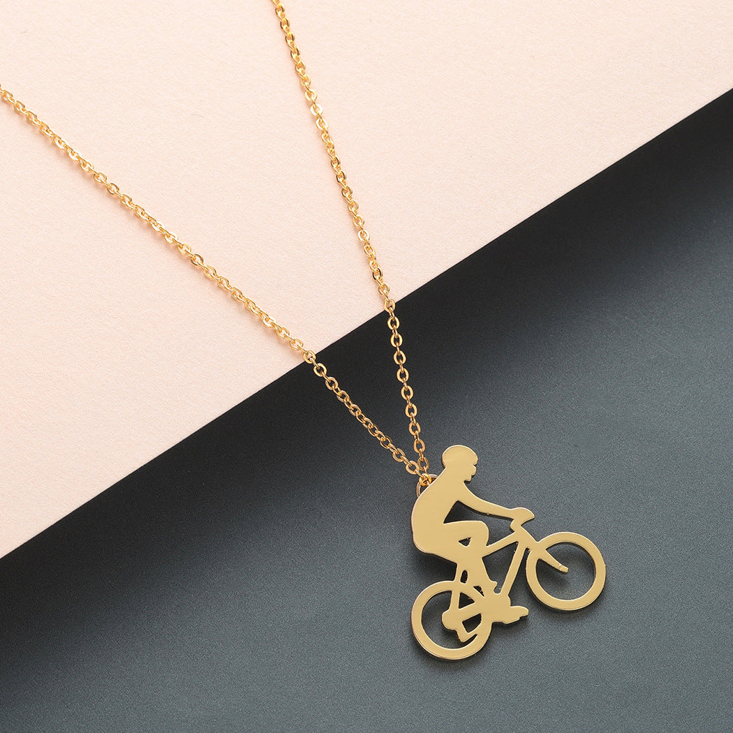 Gold necklace with a bicycle pendant on a two-tone background