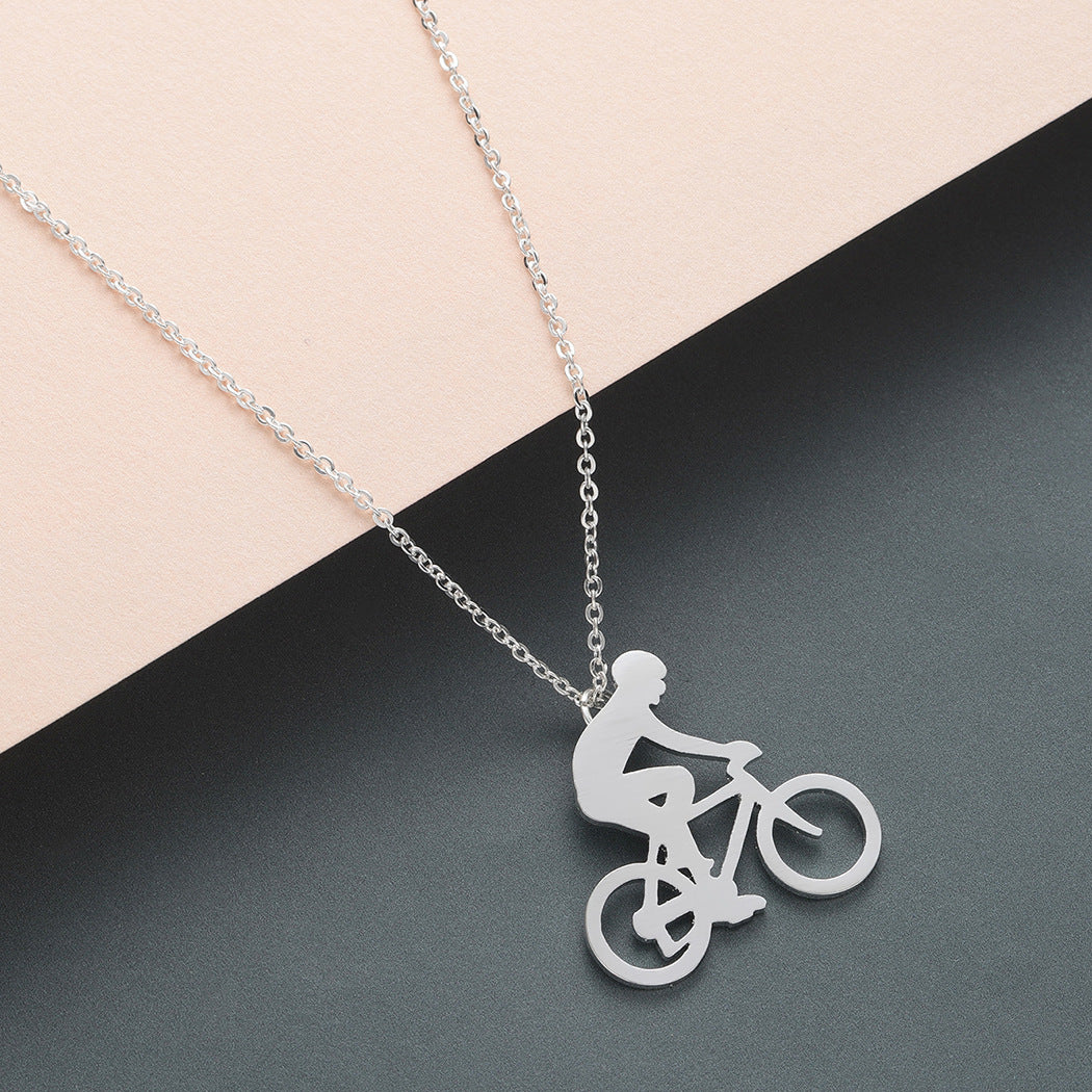 Silver necklace with a bicycle pendant on a two-tone background