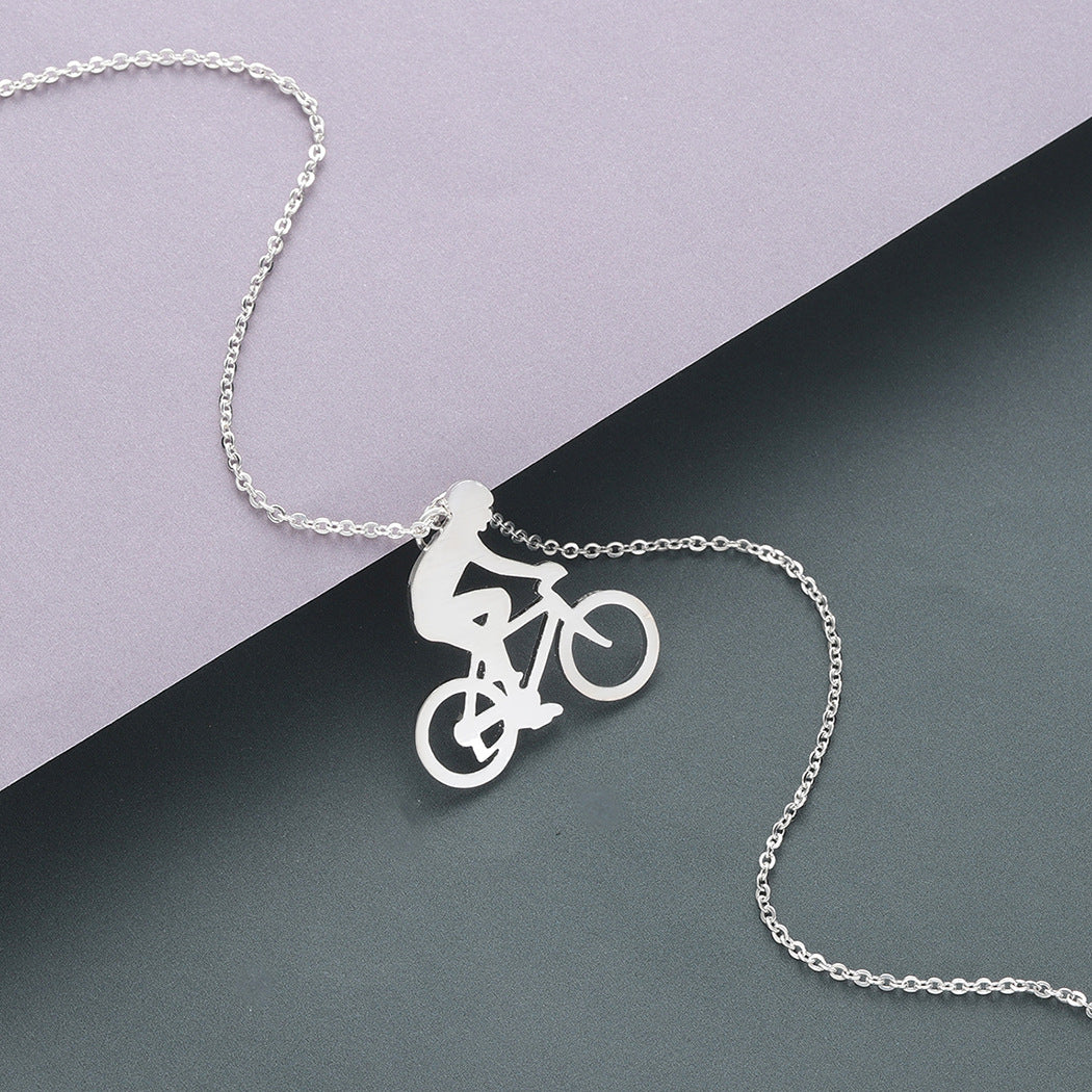 Silver necklace with a bicycle pendant on a two-tone background