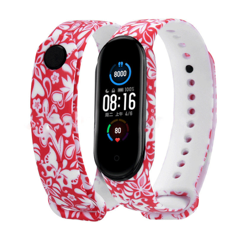 Smartwatch with a red and white floral patterned band on a white background