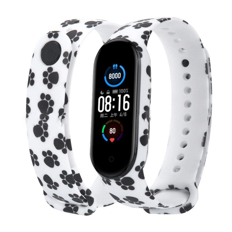 Smartwatch with a white band featuring black paw prints on a white background