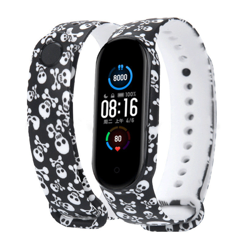 Smartwatch with a black and white skull patterned band on a white background