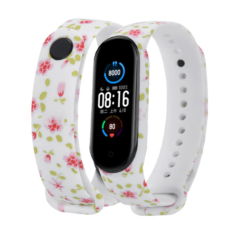 Smartwatch with floral and white bands on a white background