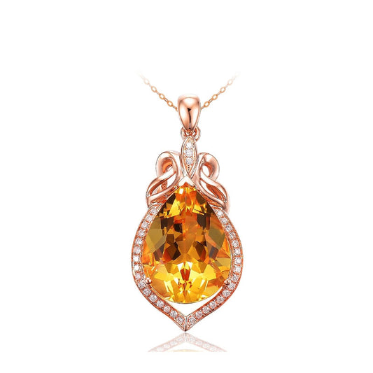 Rose gold pendant with a large orange gemstone on a white background
