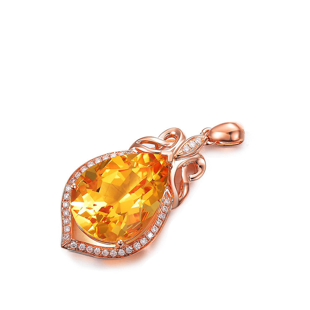 Rose gold pendant with a large yellow gemstone on a white background