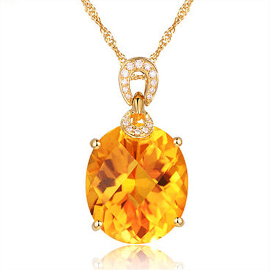 Gold necklace with a large yellow gemstone on a white background