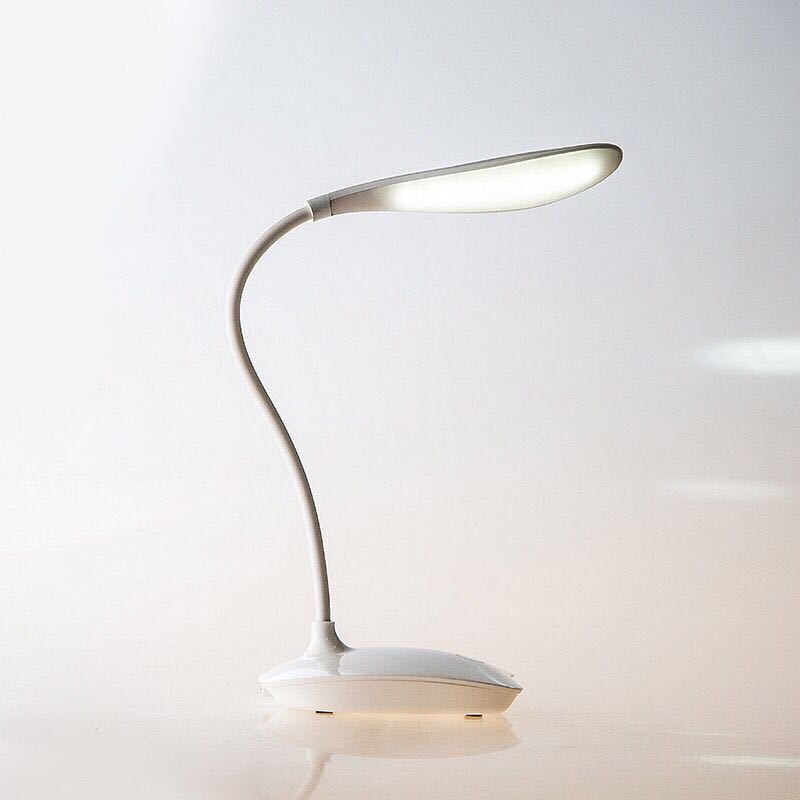 Modern desk lamp with flexible neck on a light gray background