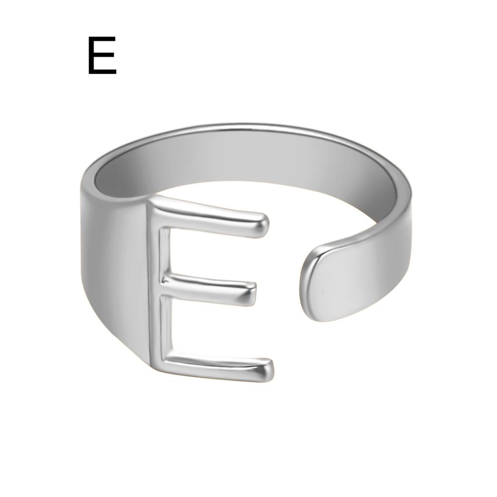 Silver ring with letter 'E' on a white background