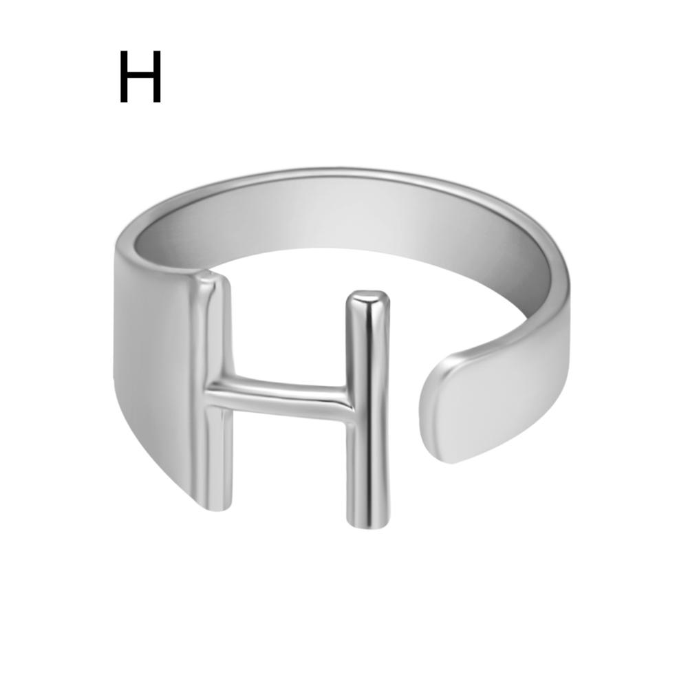 Silver ring with letter 'H' on a white background