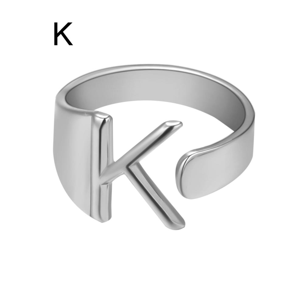 Silver ring with letter 'K' on a white background