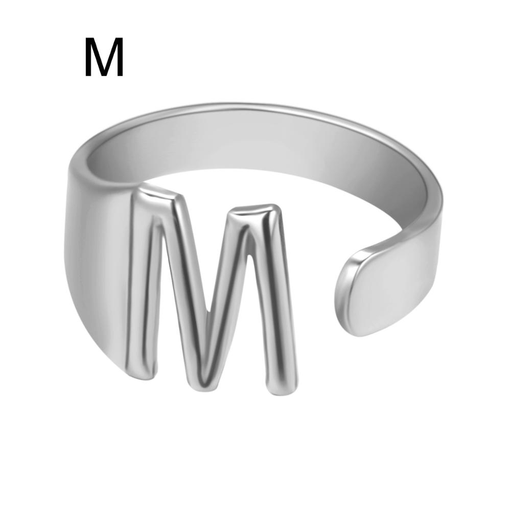 Silver ring with letter 'W' on a white background