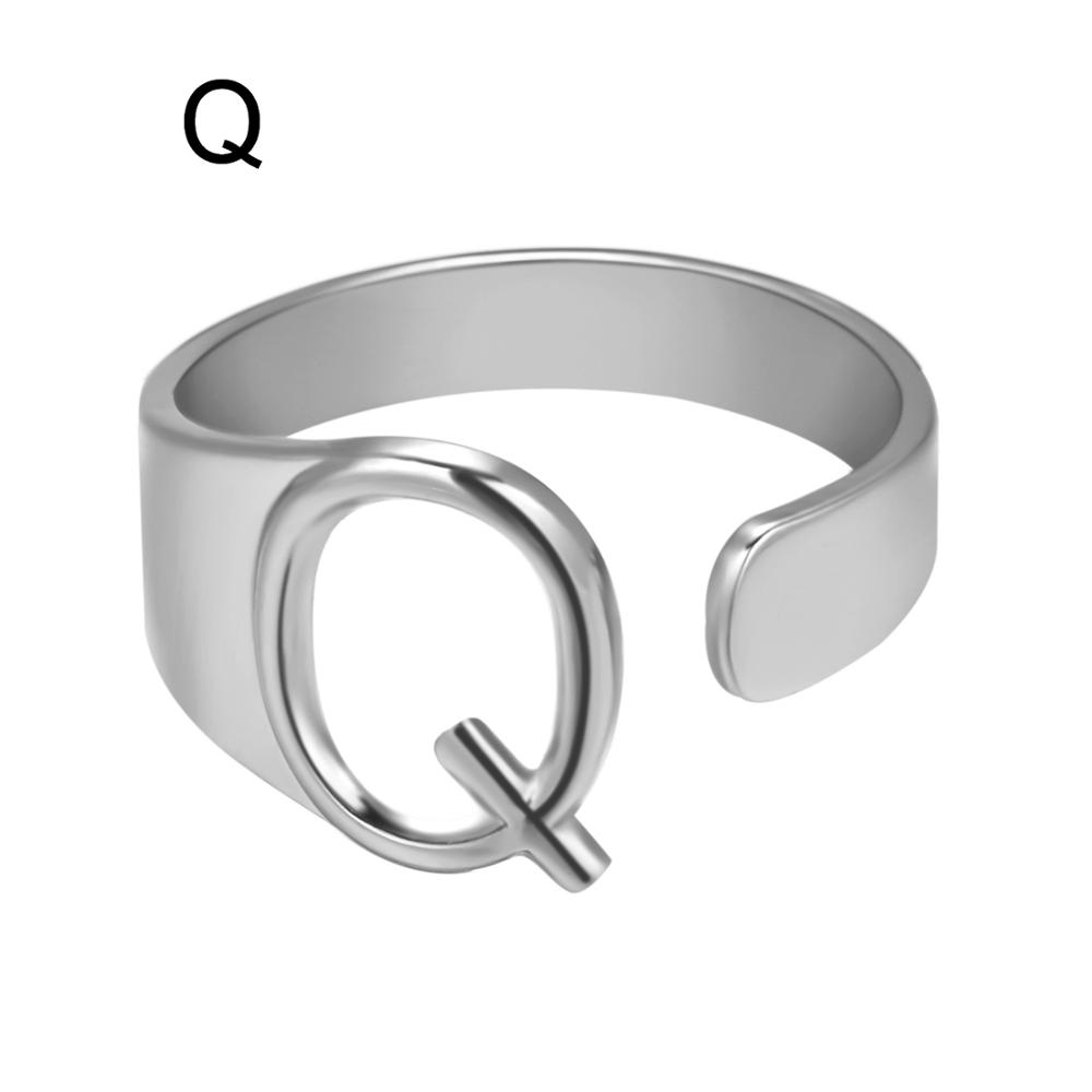 Silver ring with letter 'Q' design on a white background