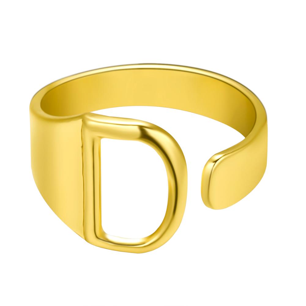 Gold ring with a unique design on a white background