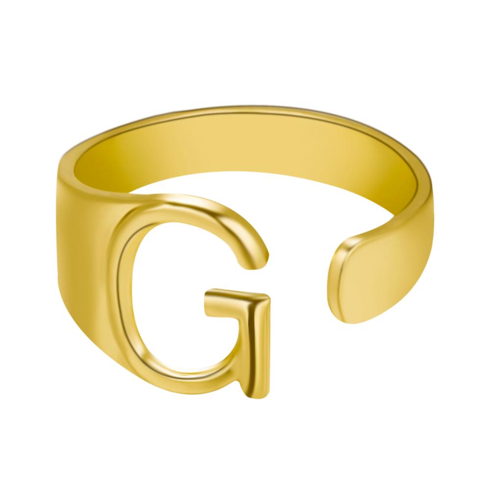 Gold ring with letter 'G' on a white background