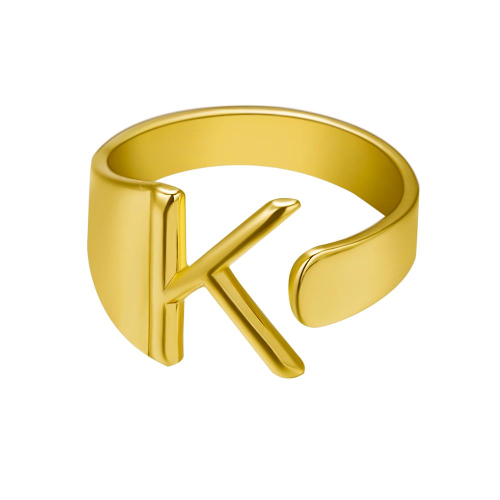 Gold ring with the letter 'K' on a white background