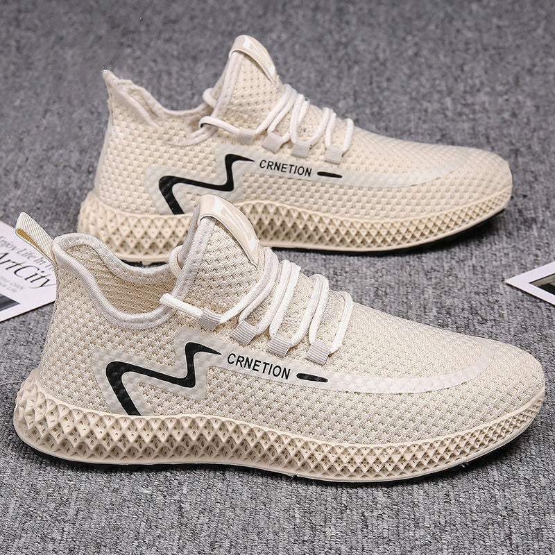 Beige running shoes with black and white branding on a gray background