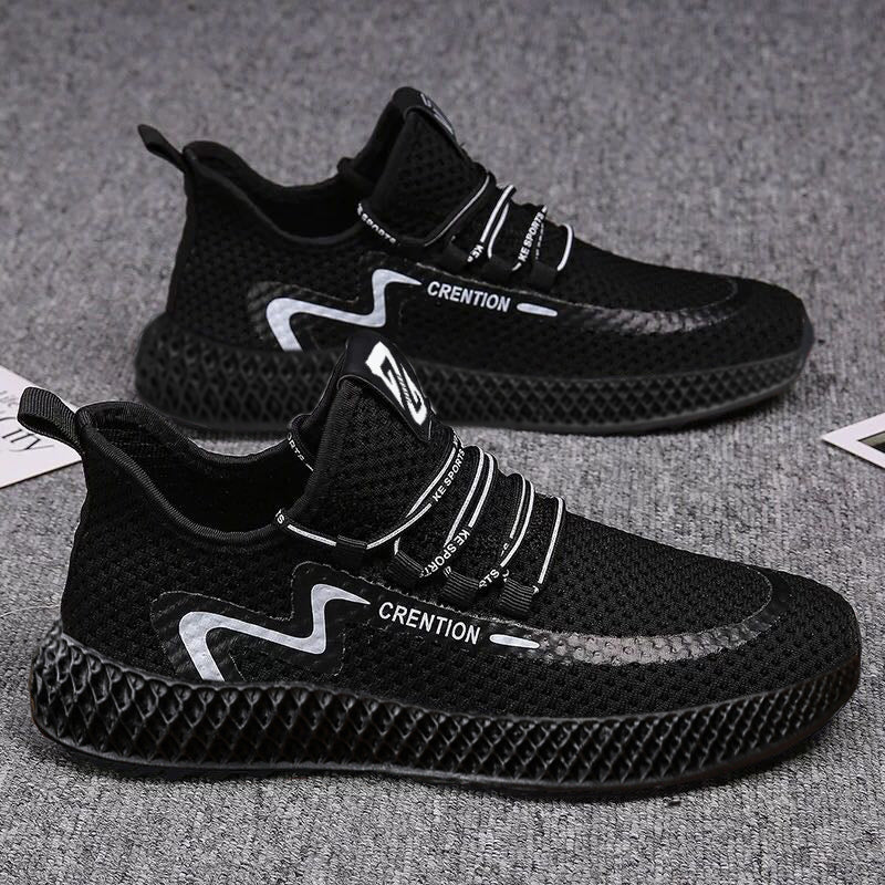 Black athletic shoes with white branding on a gray surface