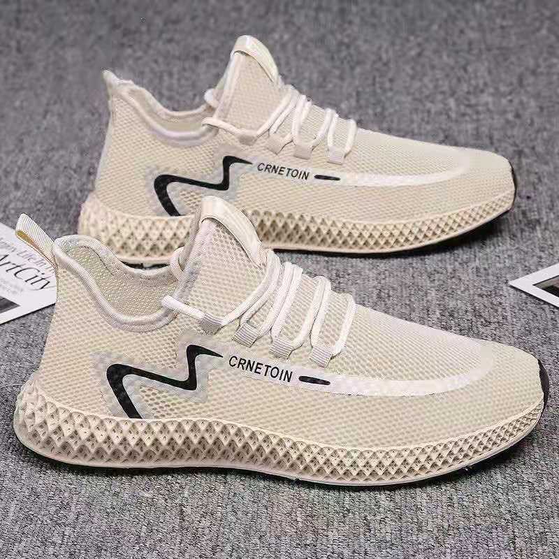 Beige running shoes with white laces on a gray surface