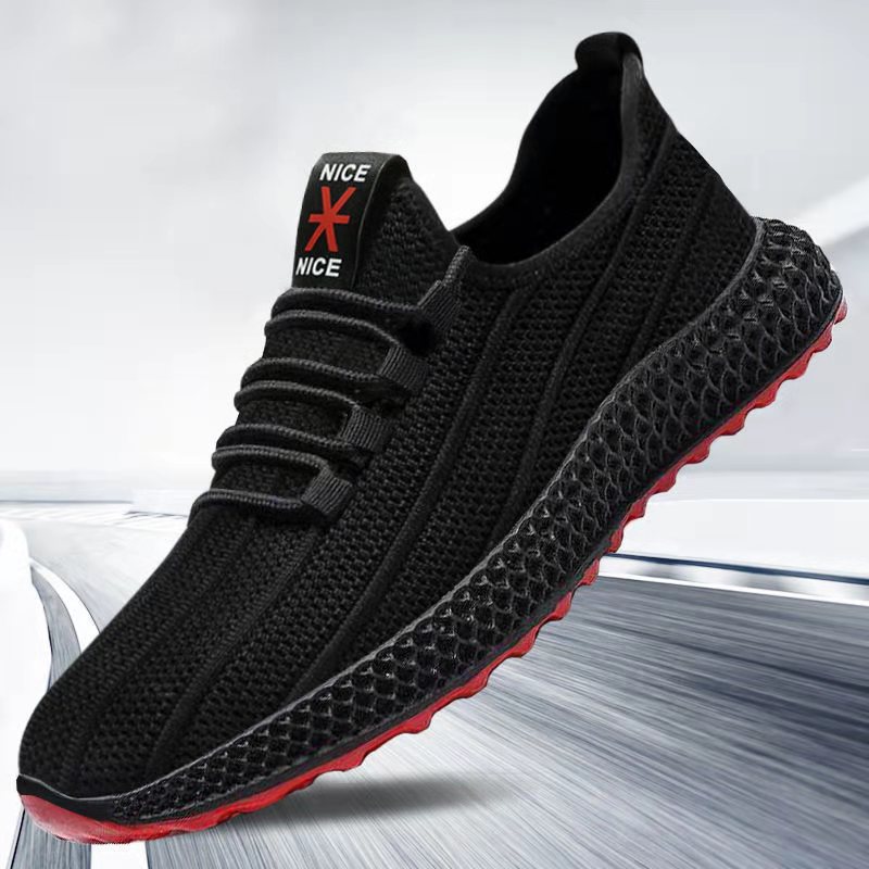 Black sneaker with red sole on a light gray background
