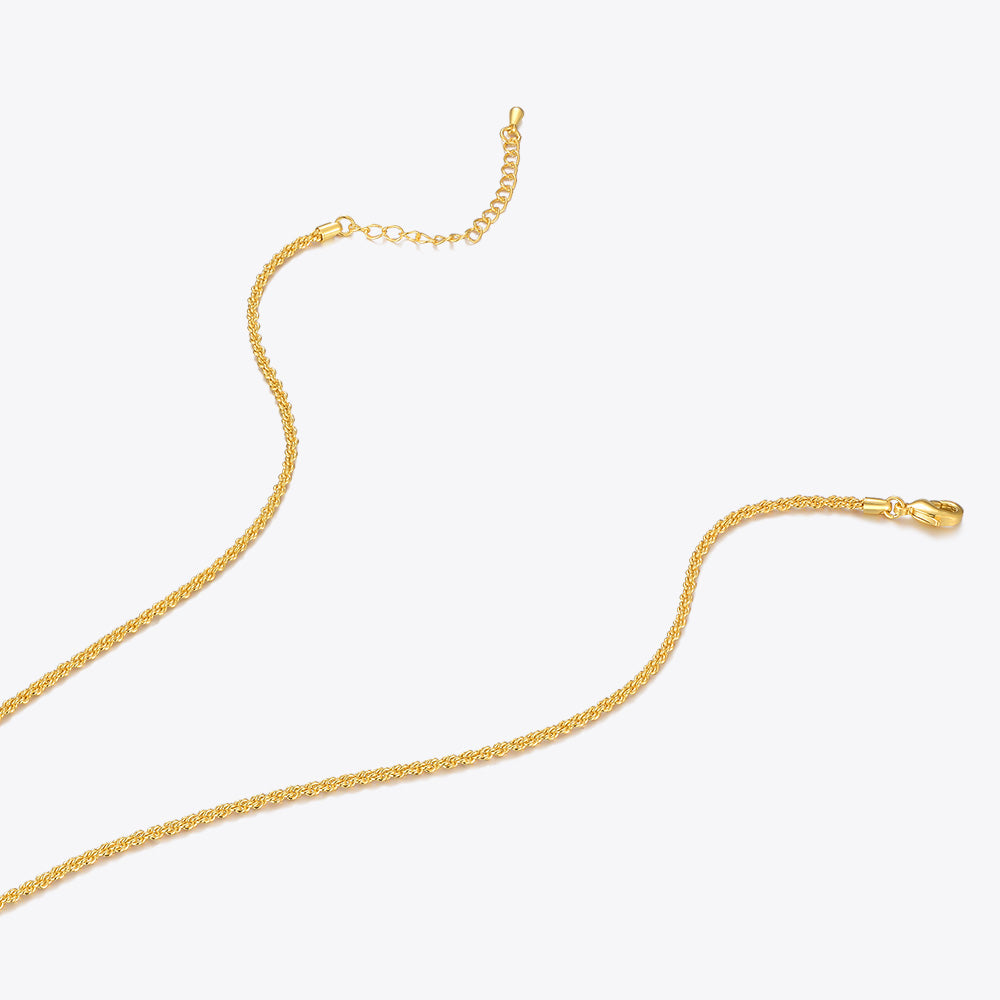 Gold chain necklace on a light beige background