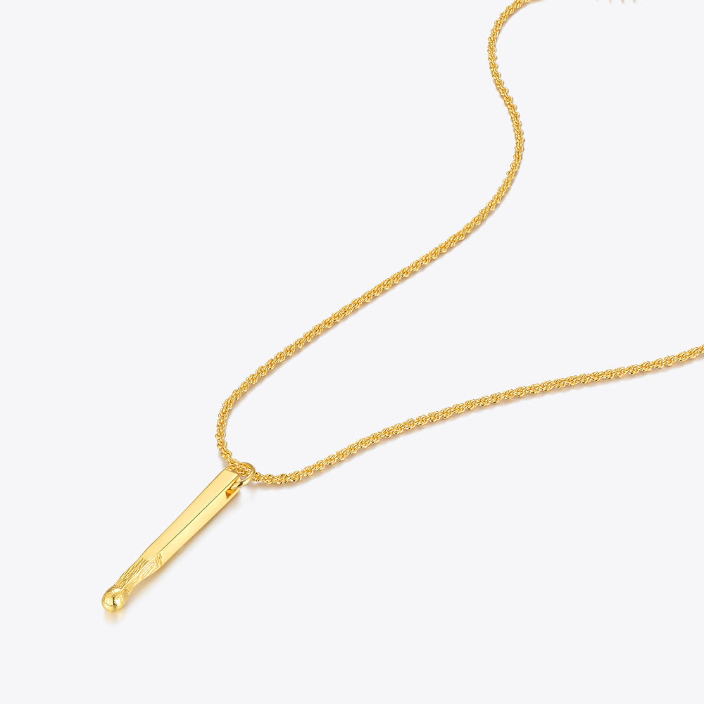 Gold necklace with a bar pendant on a white background