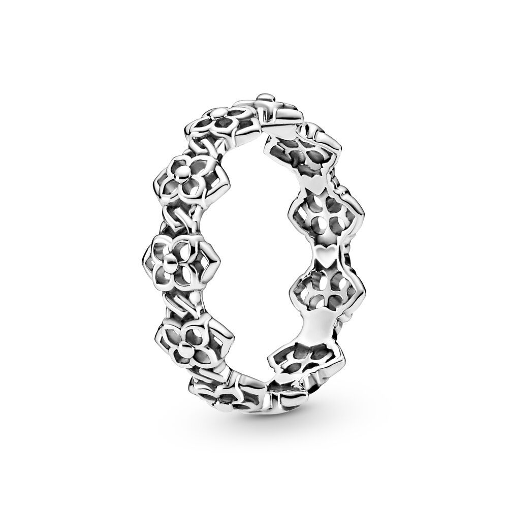 Silver ring with floral design on a white background