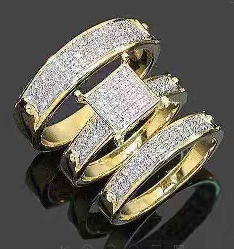 Gold ring with diamond accents on a reflective surface