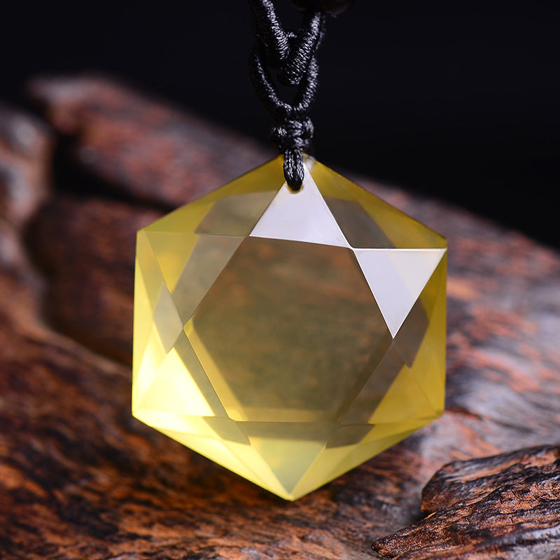 Faceted yellow crystal pendant on a dark background