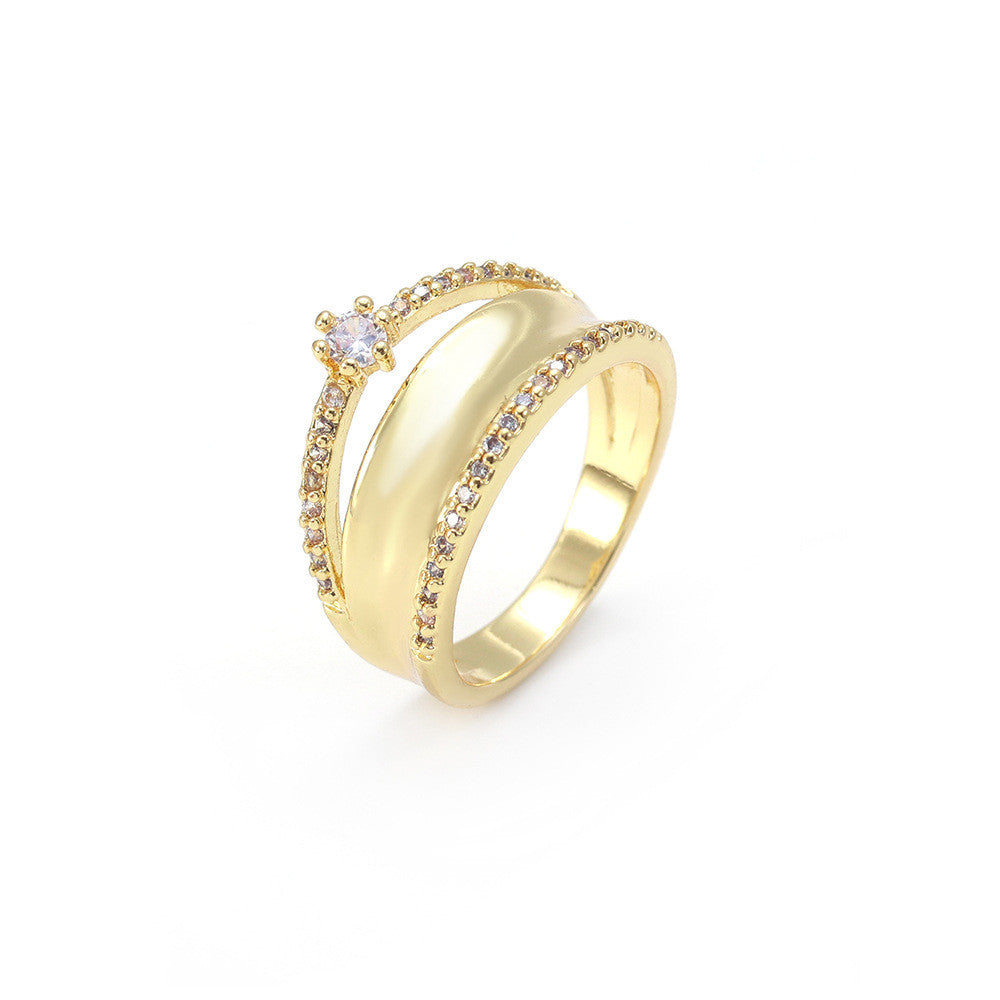 Gold ring with a central gemstone on a white background