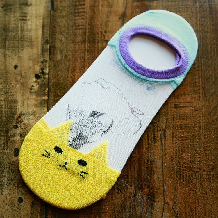 Cat-themed sock with a yellow cat face on a wooden surface