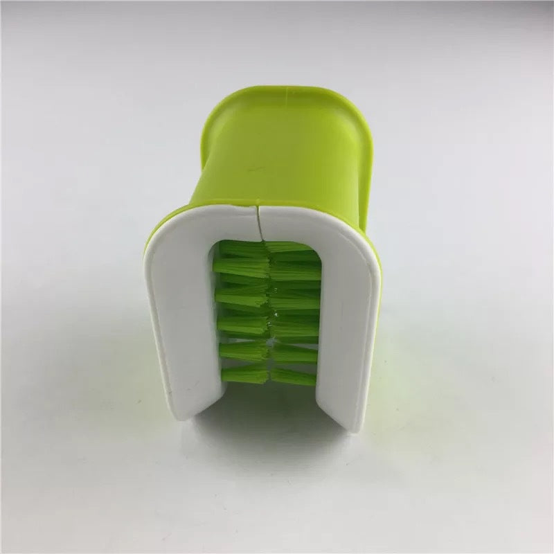 Green and white kitchen tool on a light gray background