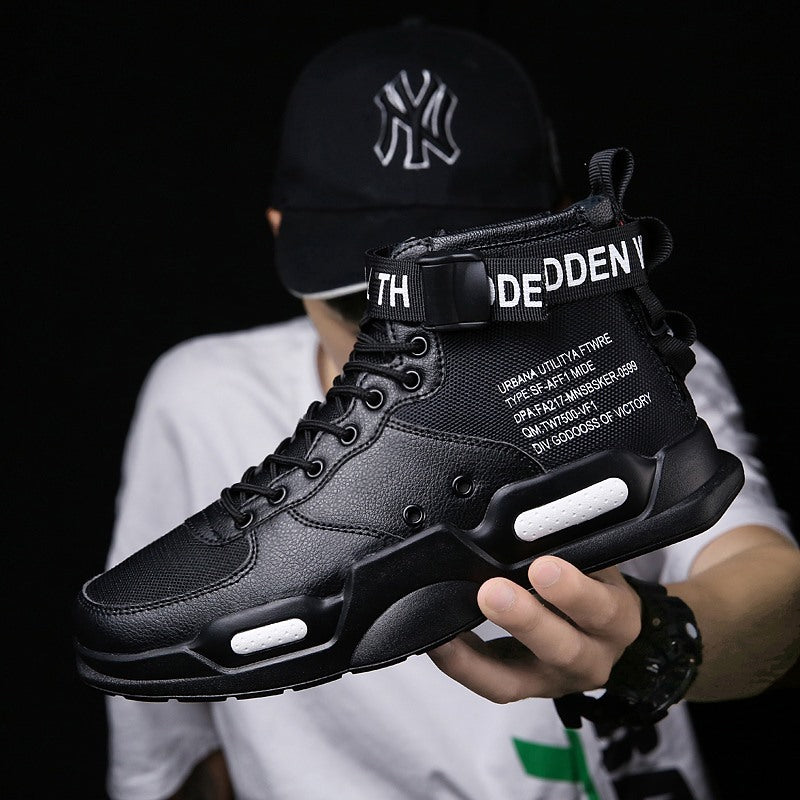 Person holding a black sneaker with text on a dark background